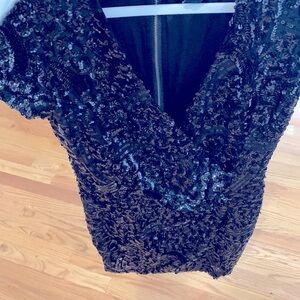 Little sequined black dress.  Size 10 knee length V-neck Zipper back. never worn